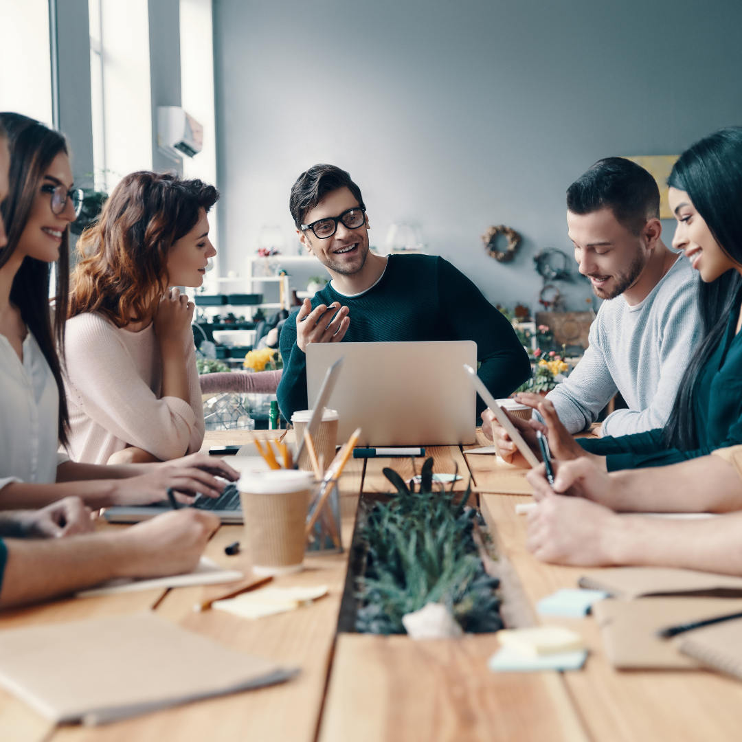 digital marketing agency employees discussing strategy at a large table